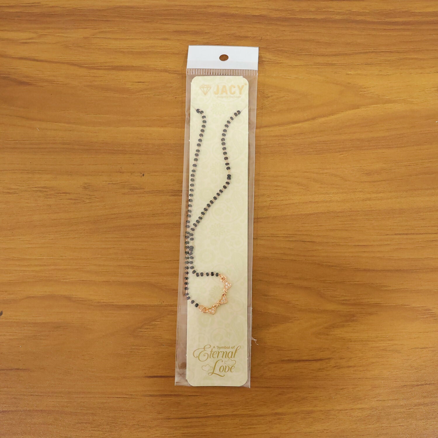 Close-up of the stylish mangalsutra pendant with crystals and black beads.