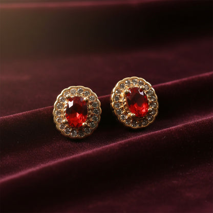 Elegant red stone stud earrings with crystal halo on a white background