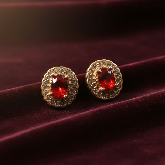 Elegant red stone stud earrings with crystal halo on a white background