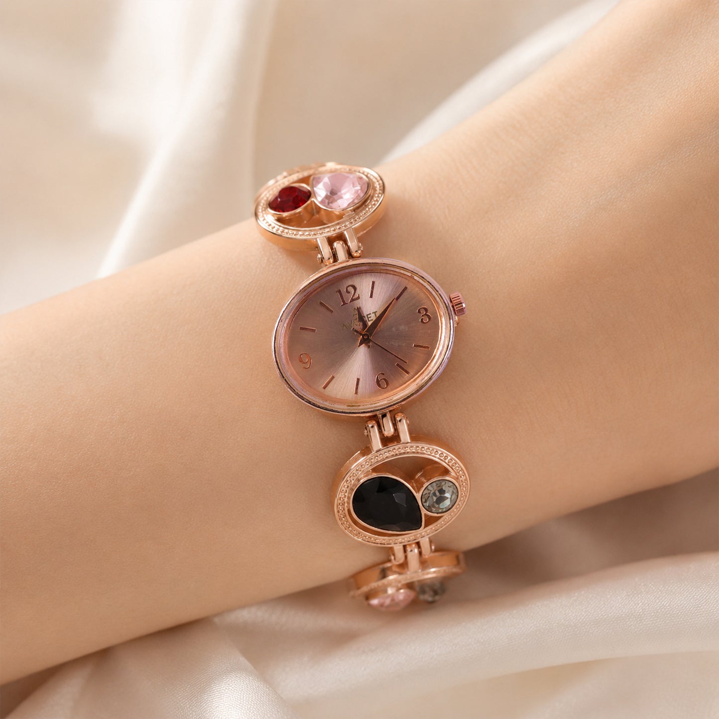Close-up of the rose gold watch dial and crystal stone detailing.