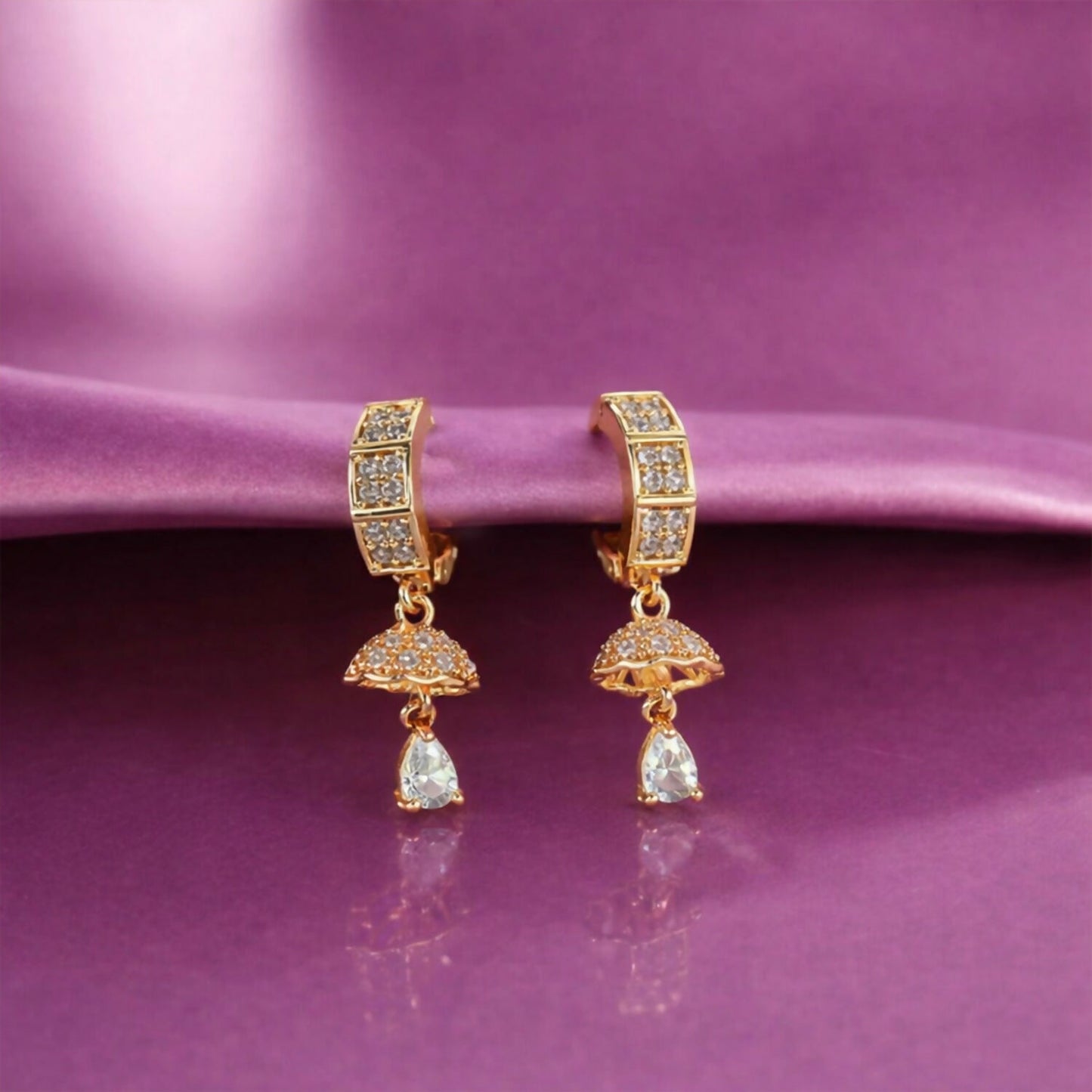 Gold-tone crystal studded huggie drop earrings front view showing sparkling crystals