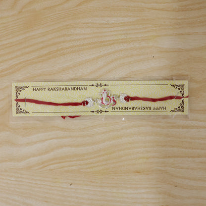 Silver Ganesha Rakhi with Red Stone Hearts and Deep Velvet Look