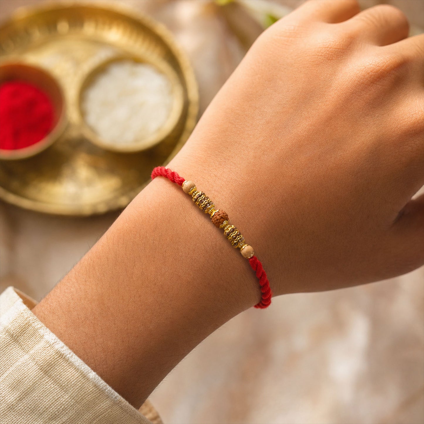 Red Thread Rakhi with Textured Golden Rudraksha-Style Bead Pendant