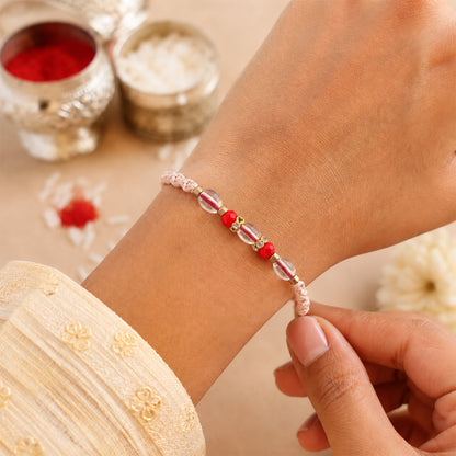 Peach Twisted Cord Rakhi with Red and Sparkling Crystal Bead Accents