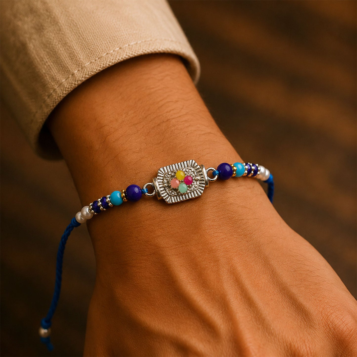Silver Floral Stone Rakhi with Royal Blue Thread, Roli Chawal Coin and Card Gift Packing