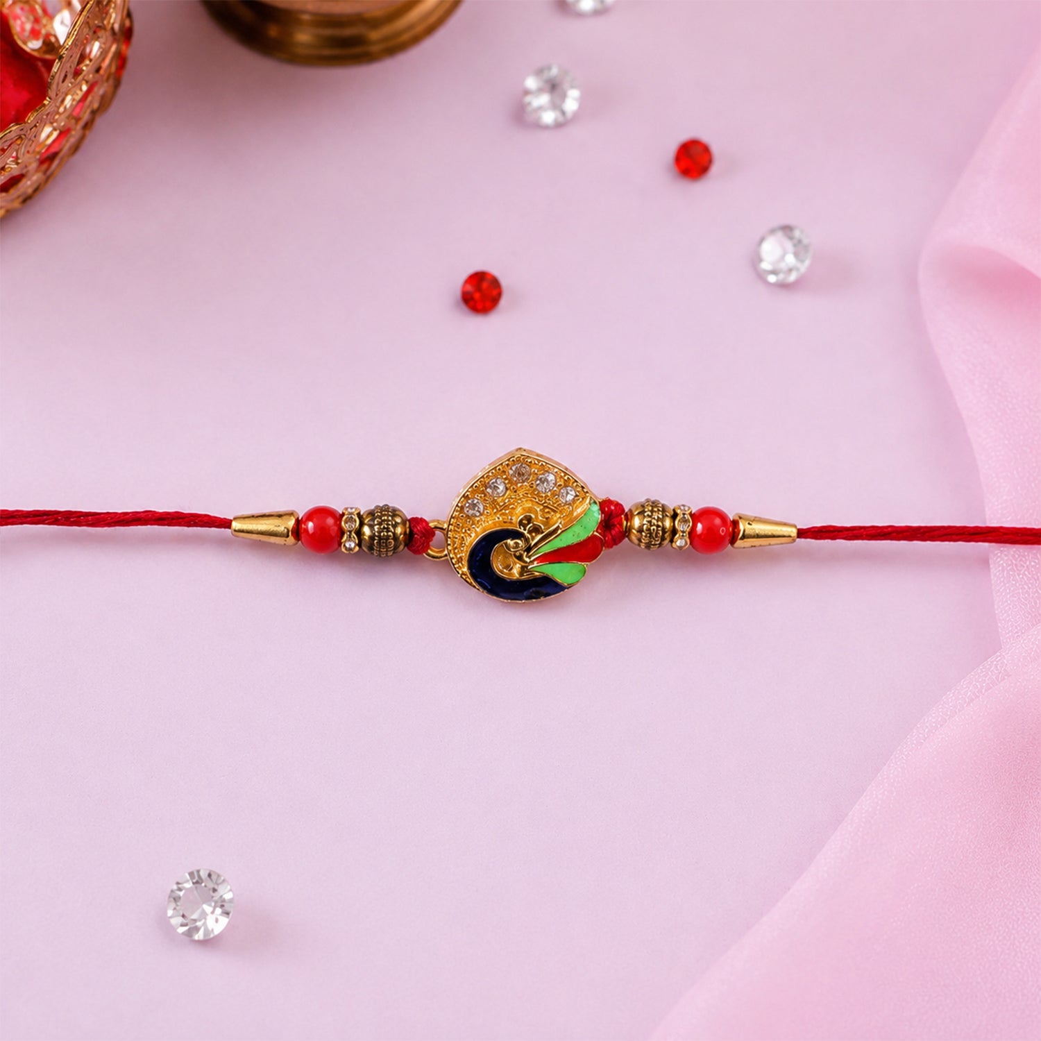 Peacock Feather Rakhi with Red Beads and Cute Mor Charm