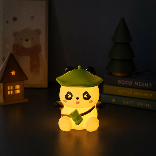 Panda silicone night lamp with green hat on bedside table