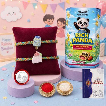 A Rakshabandhan gift set with a red cushion, two colorful bracelets with ice cream charms, a biscuit box, a silver coin, and