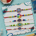 Designer Handcrafted Rakhi for Brother with Roli Tikka & Greeting Card, Pack of 8