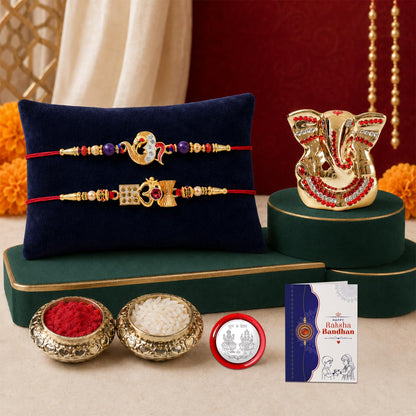 Two red thread bracelets with gold-colored charms and beads rest on a dark blue velvet pillow, next to a gold Ganesh idol