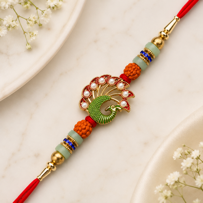 A red thread bracelet with a green peacock charm, orange and light green beads, and gold accents is centered on a white