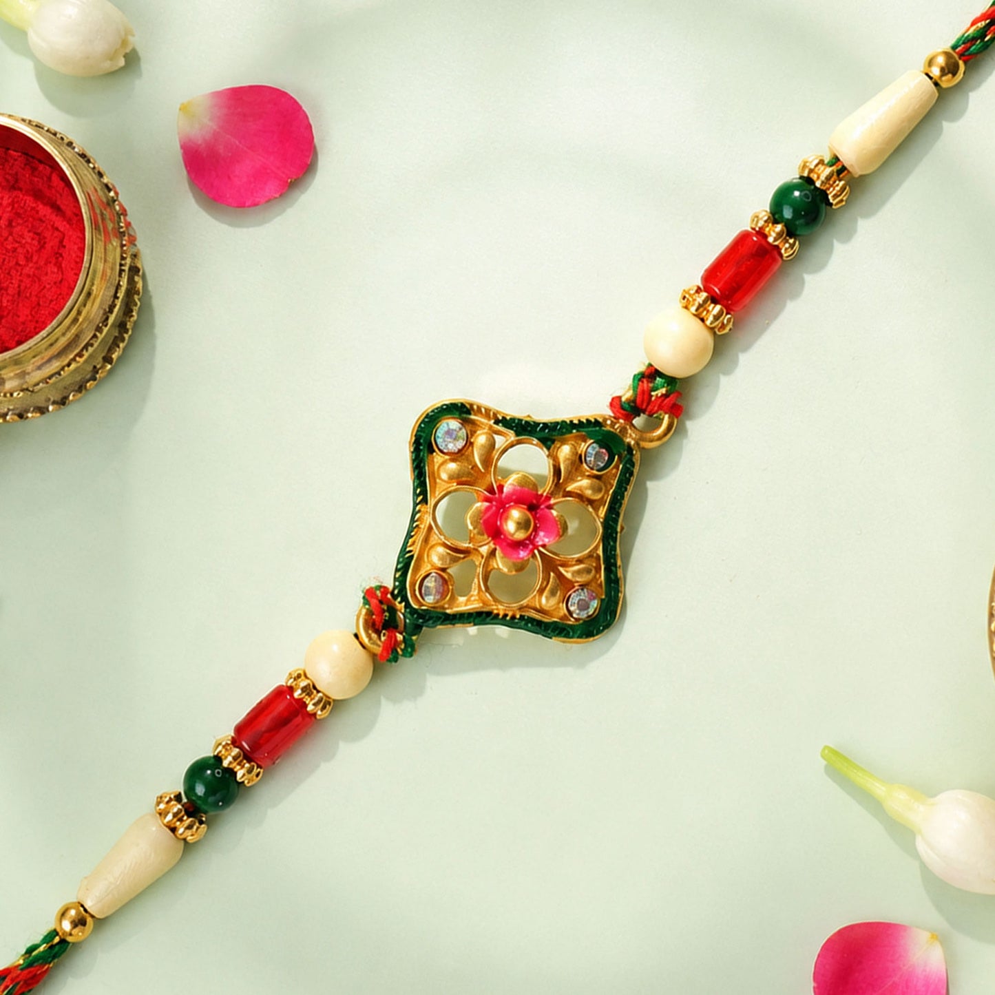Green Enamel Kite Shaped Pendant Rakhi with Red Flower Center