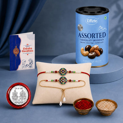 A blue can of assorted dry fruits, two bracelets on a pillow, a greeting card, a silver coin, and two small bowls of powder.