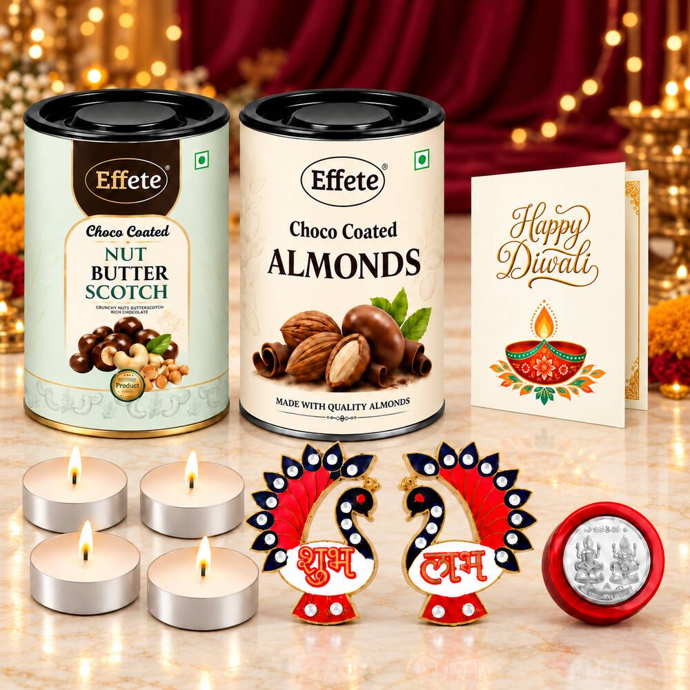 Two tins of chocolate-coated nuts, four glowing tealight candles, two red and blue peacock decorations, and a Happy Diwali