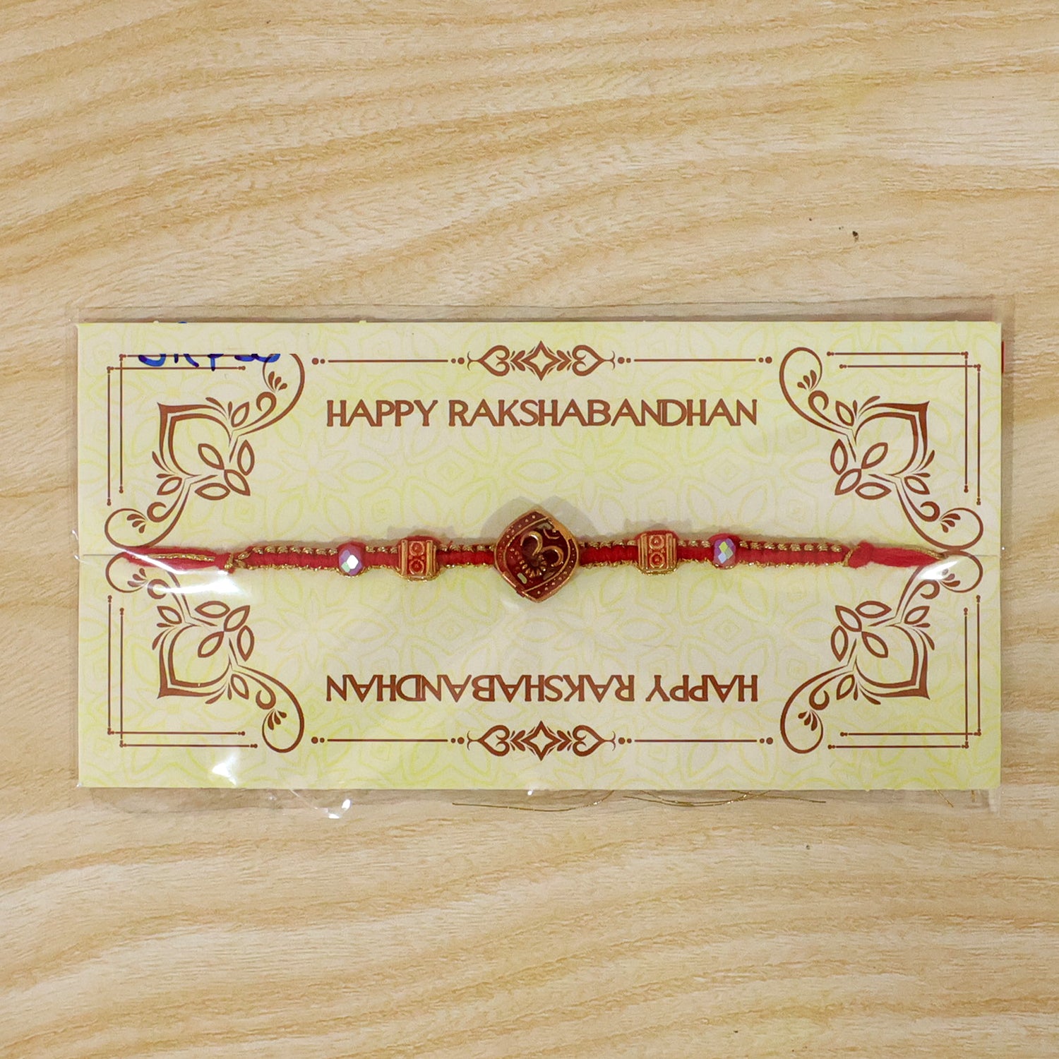 Red Swirl Stone Rakhi with Golden Detail and Beautiful Festive Centre Styling