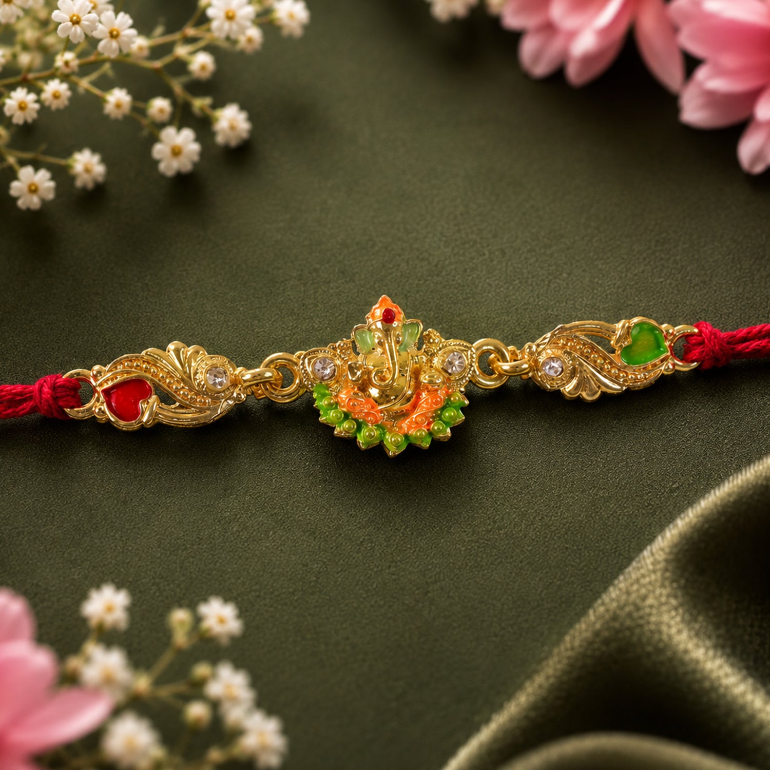 Gold-Toned Lord Ganesha Rakhi with Orange-Green Enamel, Crystal Accents & Red Thread