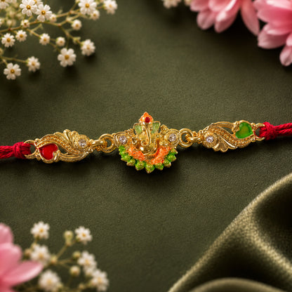 Gold-Toned Lord Ganesha Rakhi with Orange-Green Enamel, Crystal Accents & Red Thread