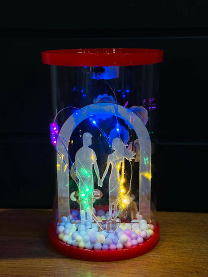 Romantic Couple Dome LED Night Lamp with Artificial Flowers & Pastel Beads | Transparent Acrylic Cylinder Gift Light | Decorative Showpiece for Bedroom, Living Room & Gifting – Warm Light, Battery Operated