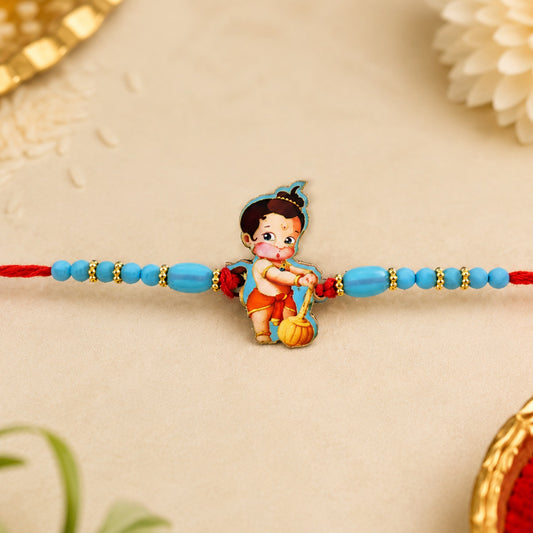 Vibrant Hanuman Kids Rakhi with blue beads and red thread, ready for Raksha Bandhan.
