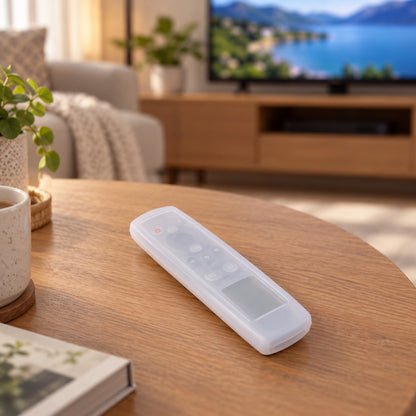 A translucent silicone remote control cover rests on a wooden coffee table in a living room setting.