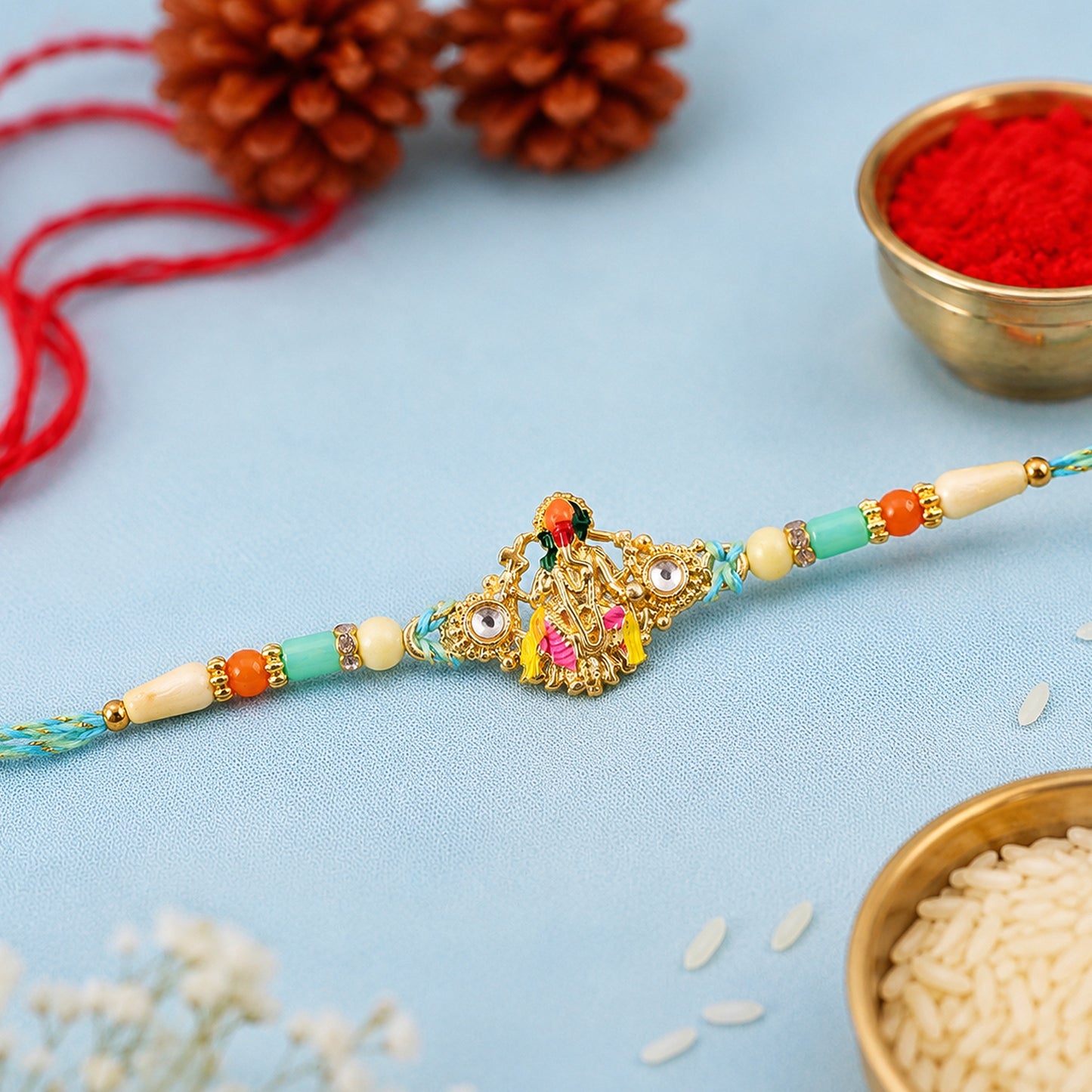 Lord Krishna Flute Pendant Rakhi with Pink and Yellow Drapery