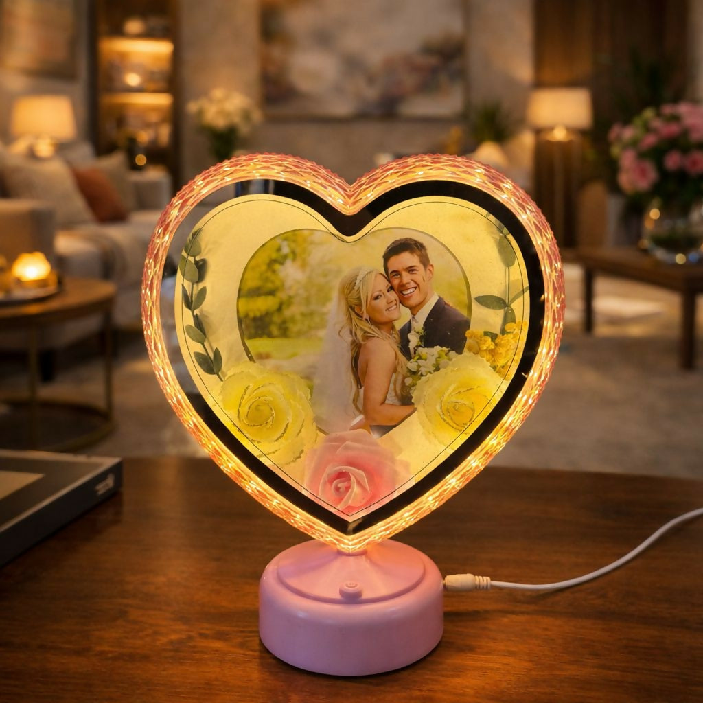 Heart-shaped LED photo frame with warm glowing lights on table