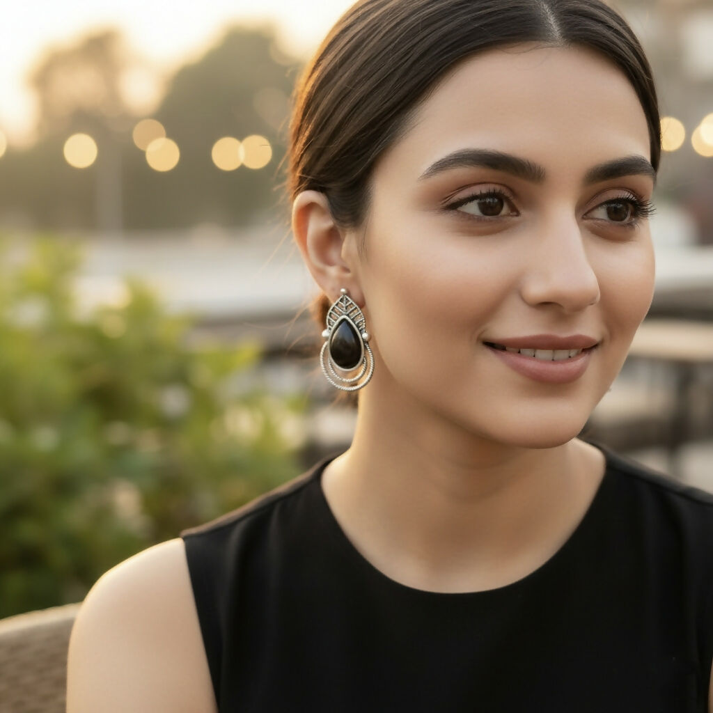 Close-up of intricate leaf detailing on oxidized silver earrings