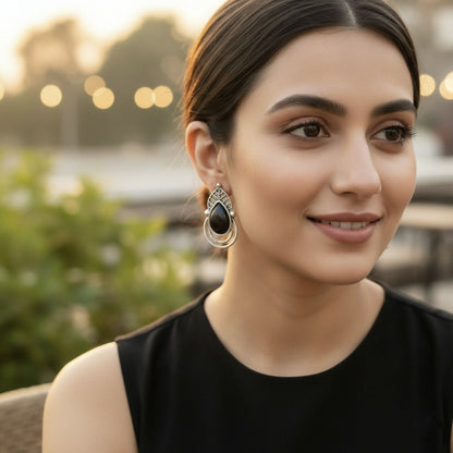 Close-up of intricate leaf detailing on oxidized silver earrings