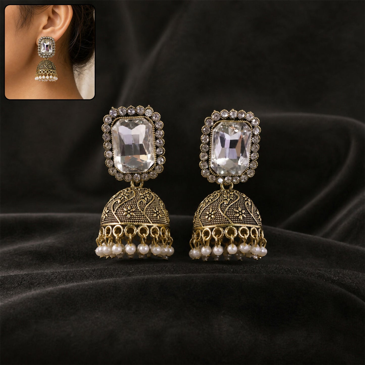 Antique gold jhumka earrings with clear stone studs and pearl drops front view