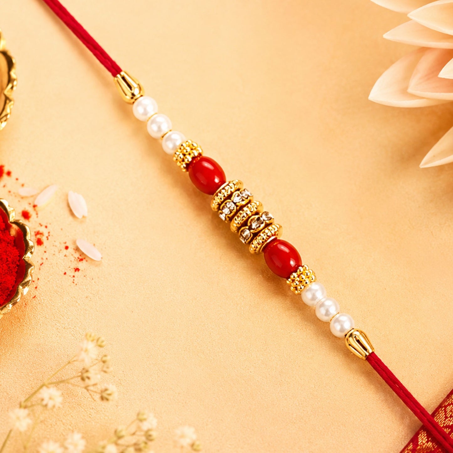 Elegant Pearl Beaded Rakhi with red accents and golden details for Raksha Bandhan.