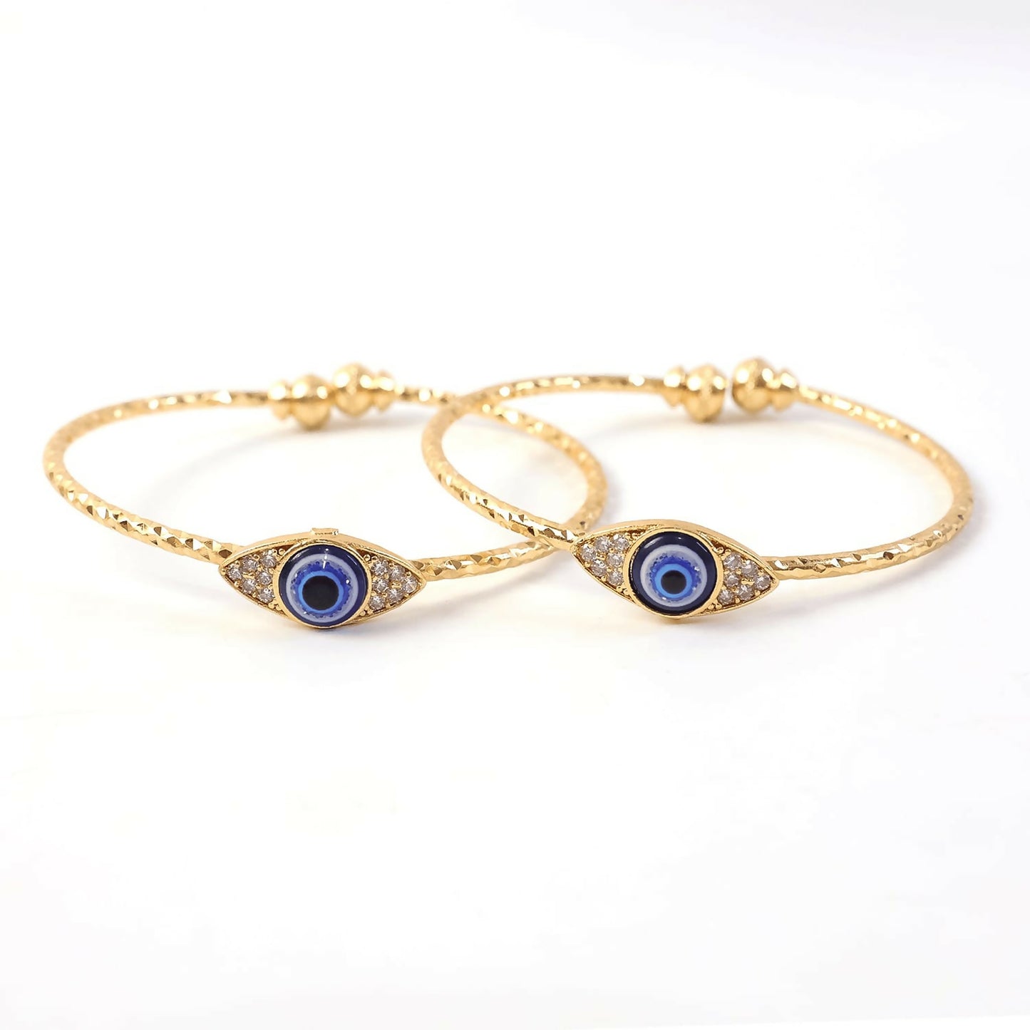 Gold evil eye bangle worn on wrist highlighting design and fit
