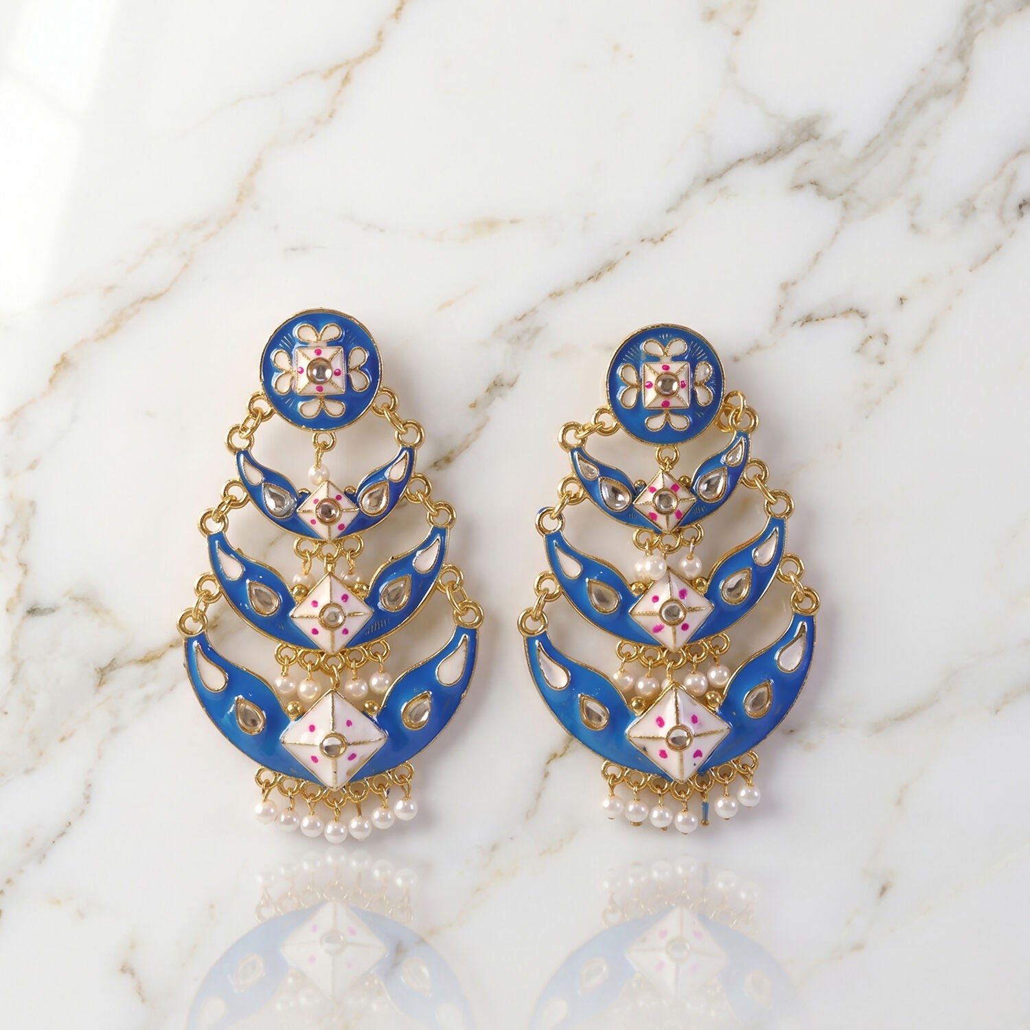 Royal blue layered pearl earrings pair on white background