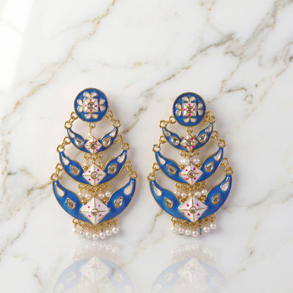 Royal blue layered pearl earrings pair on white background