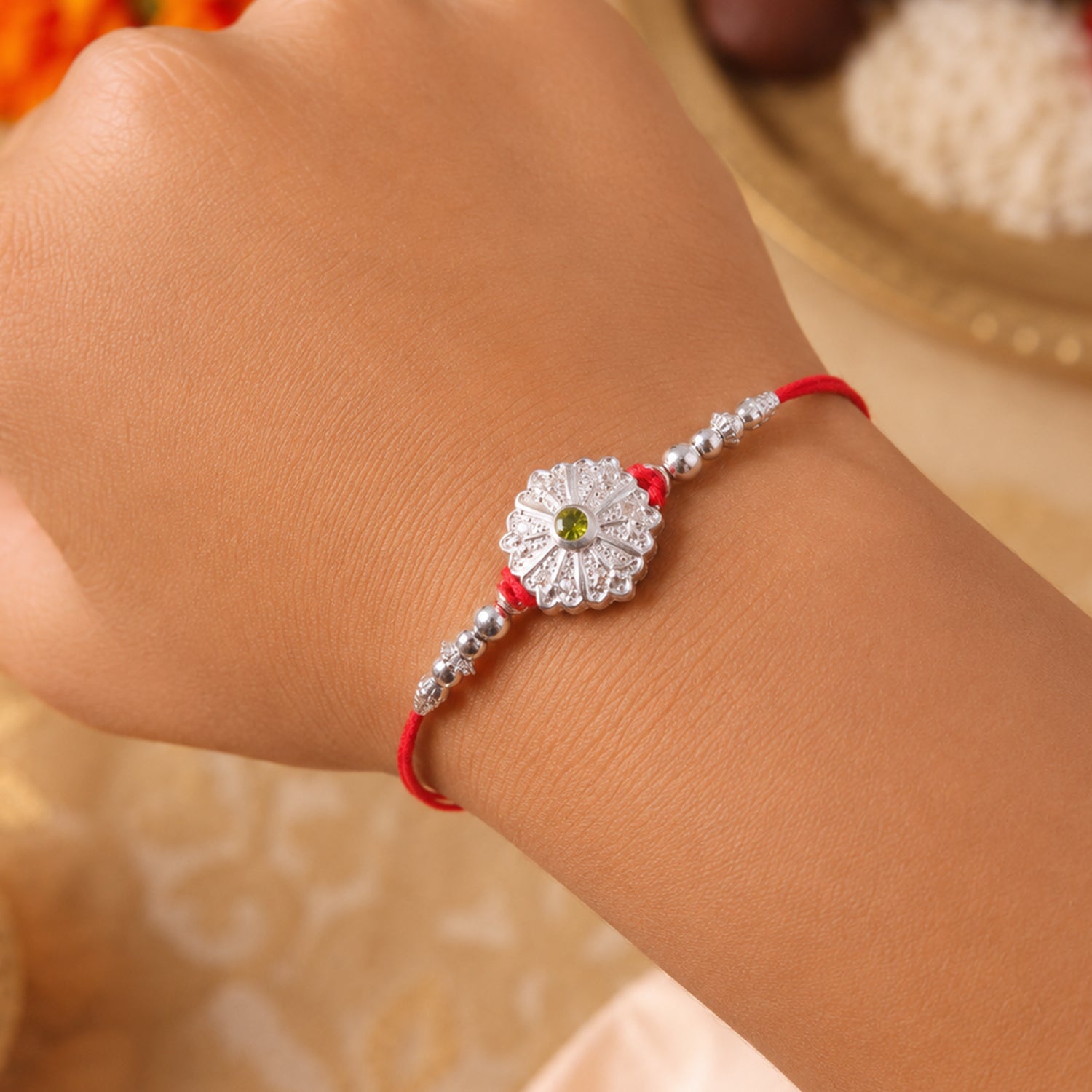 White Daisy Rakhi with Silver Beads and Soft Green Stone Center
