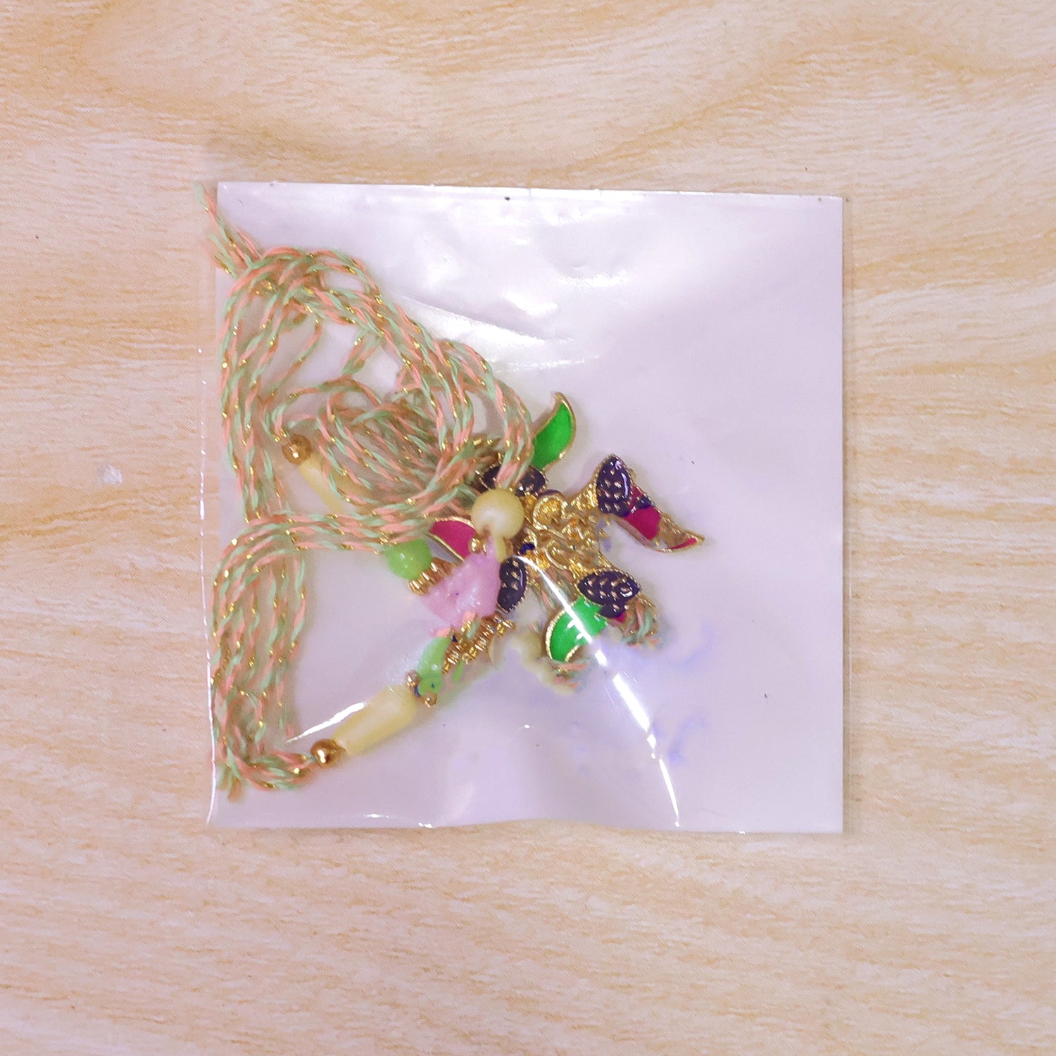 Ornate Rakhi with Butterfly Flower Charm and pearl accents in bead line for Gift Use