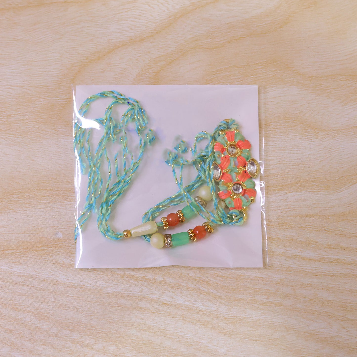 Marigold Style Floral Kundan Pendant Rakhi with Teal Beads
