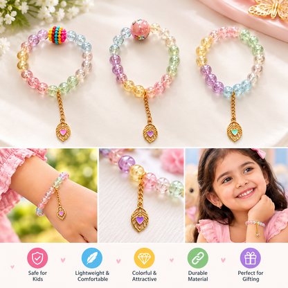 Three pastel beaded bracelets with gold leaf charms, displayed on a white surface with small white flowers.