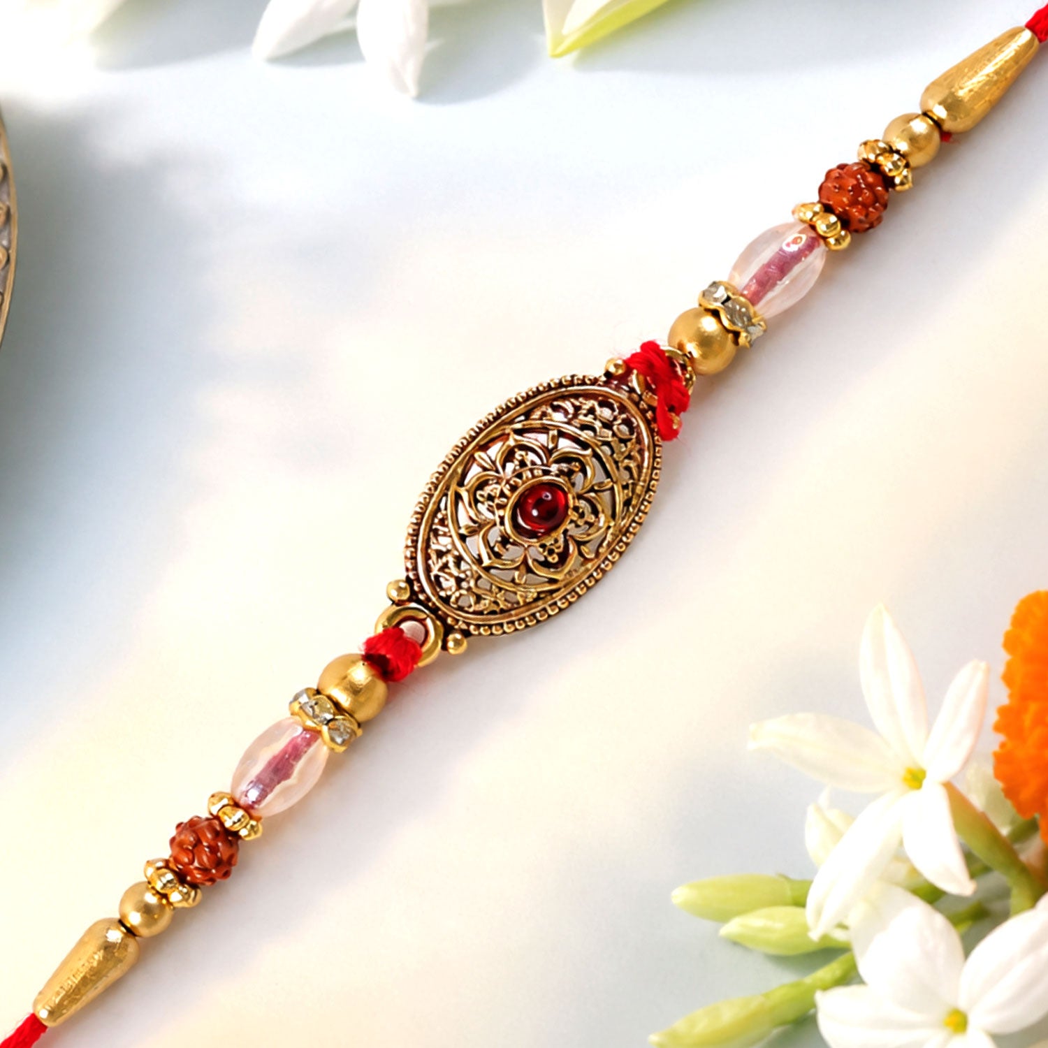 Oxidized Gold Oval Pendant Rakhi with Red Stone and Rudraksha Beads