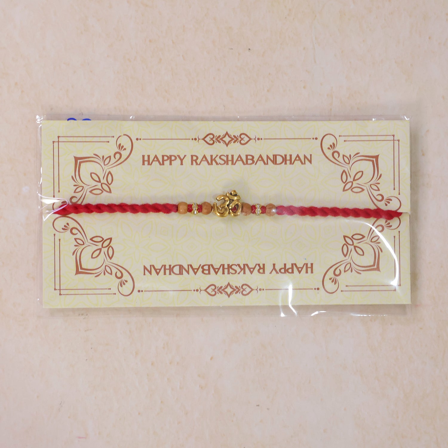 Navy-Red Thread Rakhi with Golden Om Pendant and Beaded Accents
