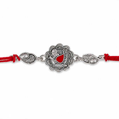 Ornate Rakhi featuring Silver Round Charm, metal trims and chain look for Gifting
