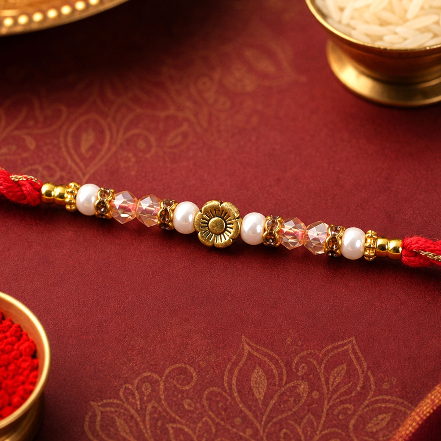 Red Thread Rakhi with Pearls, Crystal Beads and a Gold Flower Charm