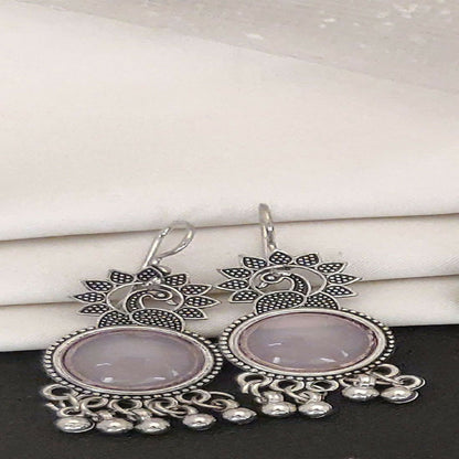 Close-up view of german silver plated oxidized jhumka earrings with peacock motif