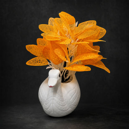 Stylish home decor with white ceramic swan vase and vibrant orange leaves