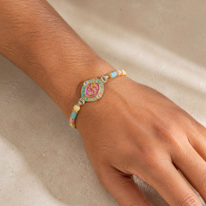 Turquoise Om Pendant Rakhi with Pink Kundan and Pastel Beads