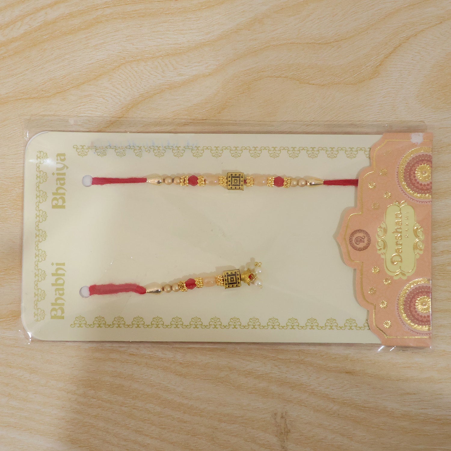 Graceful Circular Medallion Bhai Bhabhi Rakhi with Oval Pendant for Festive Gifting