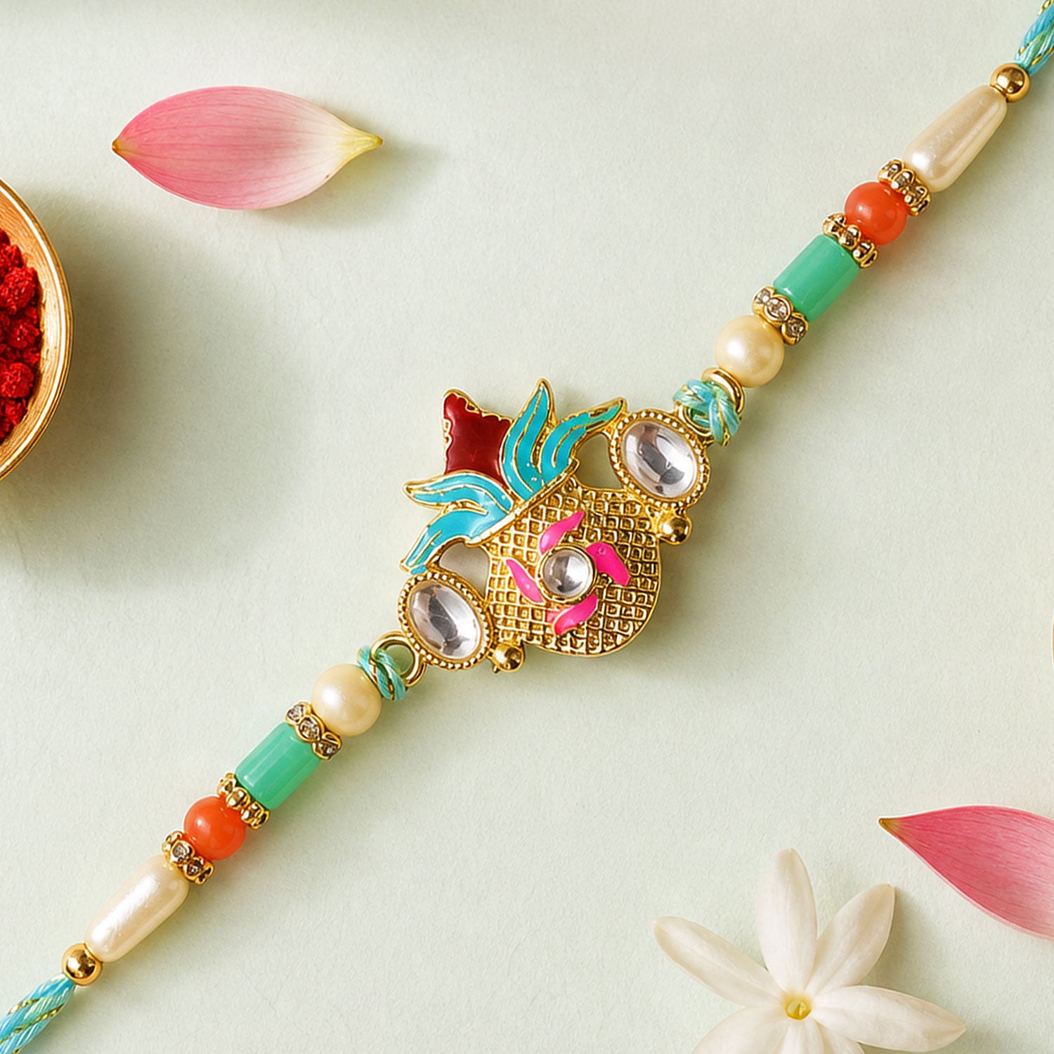 Sacred Nariyal Kalash Golden Metallic Motif Rakhi with Sea Green & Coral Beads