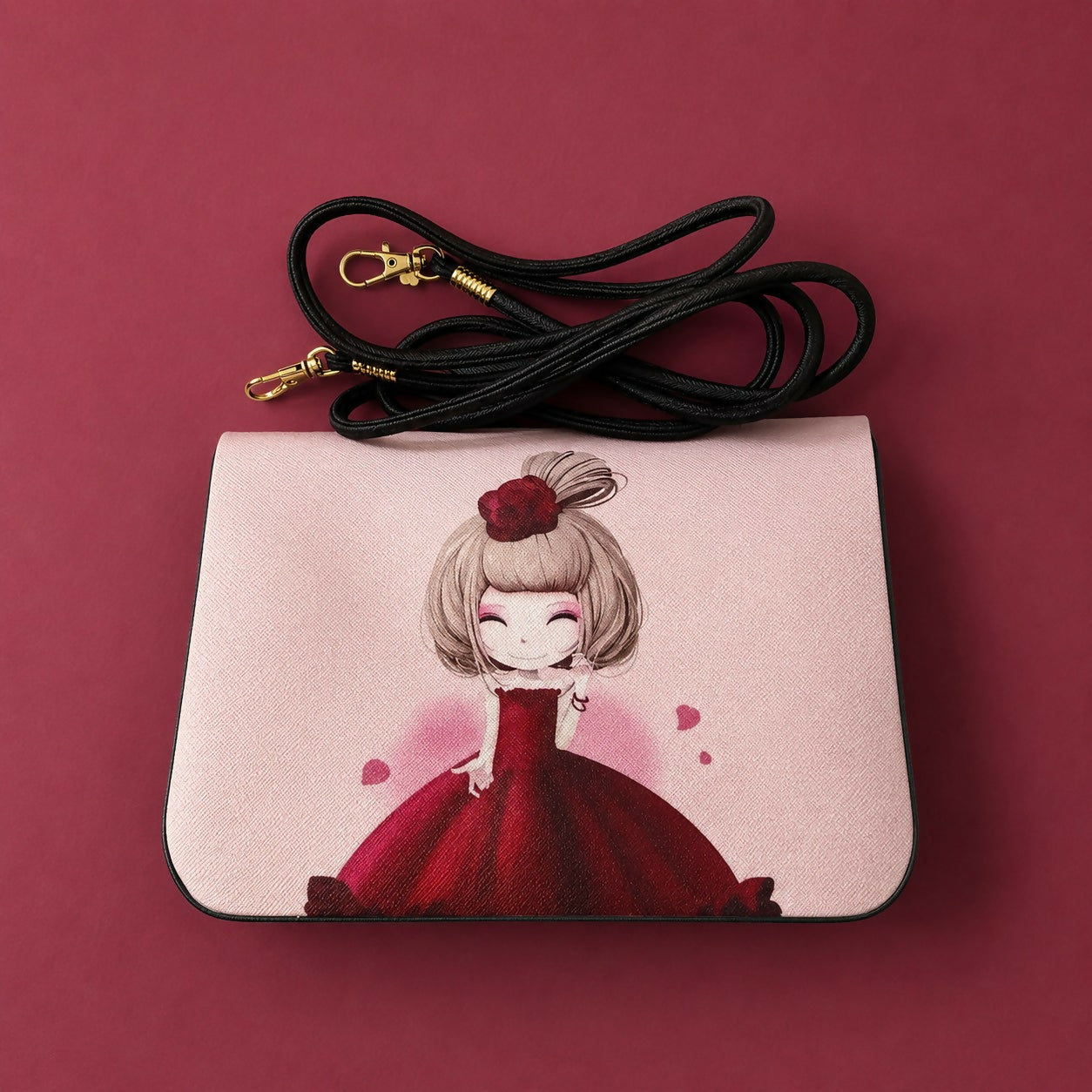Pink sling bag with cartoon girl print carried by a girl