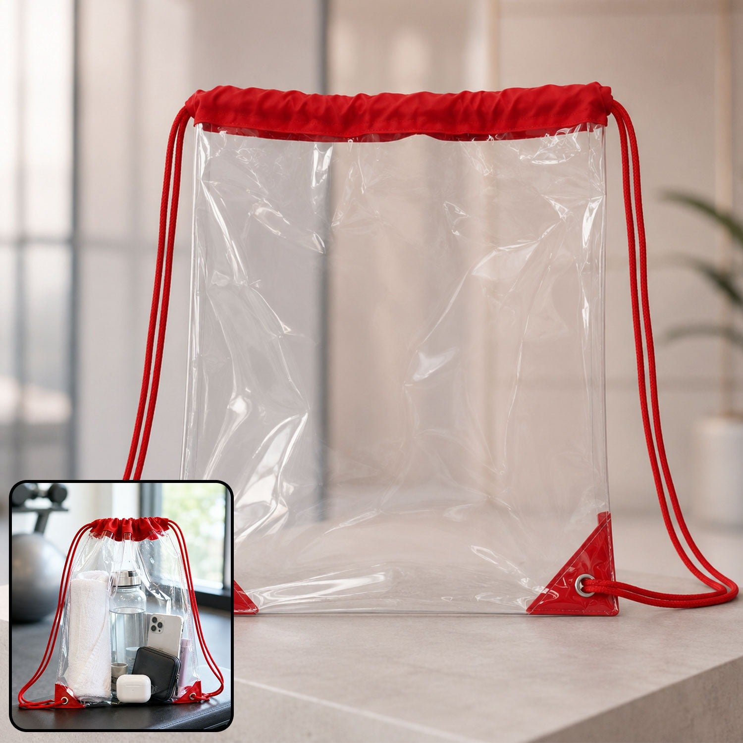 Clear drawstring bag with red cords and reinforced corners, shown on a light surface with a gym setting inset.