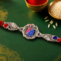 Silver-Toned Radha Krishna Rakhi with Colorful Enamel, Crystal Accents & Designer Red Thread