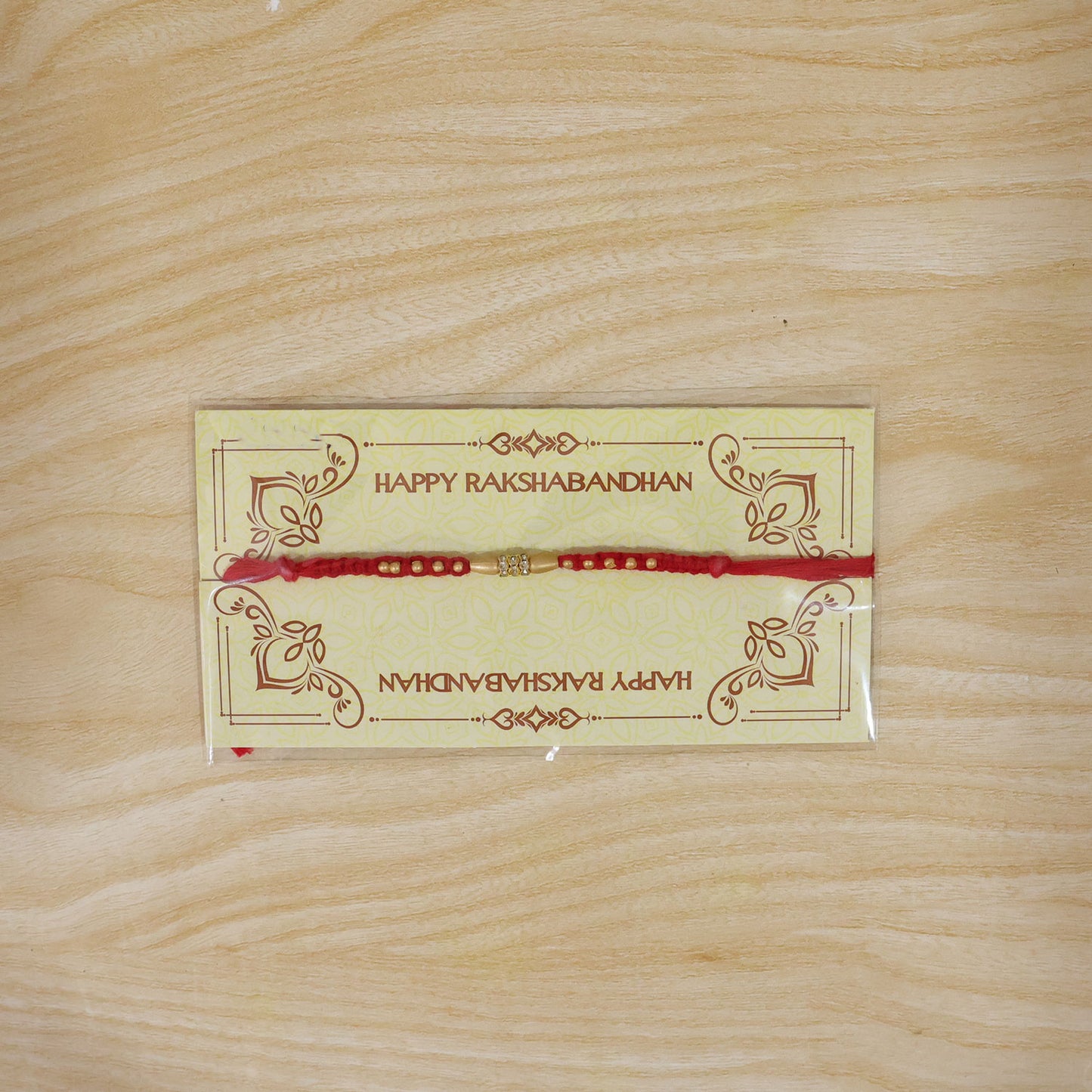 Minimal Red Thread Rakhi with Small Golden Bead Pendant Accents